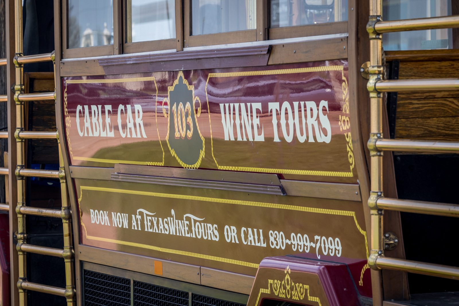 Gold Cable Car Wine Tours panel with booking details on the car's side