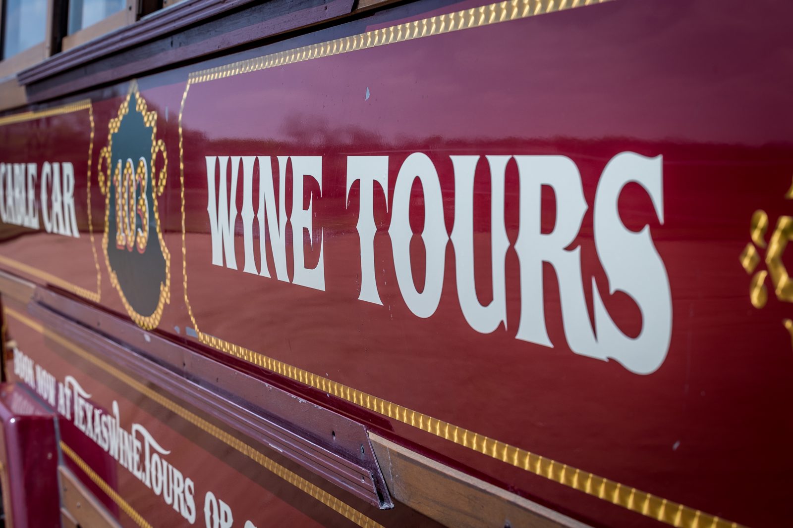 Hand-painted maroon and gold Wine Tours livery on our restored cable car